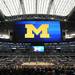 A huge screen hangs over the court set up on the field at Cowboys Stadium in Arlington, Texas on Thursday, March 28, 2013. Melanie Maxwell I AnnArbor.com